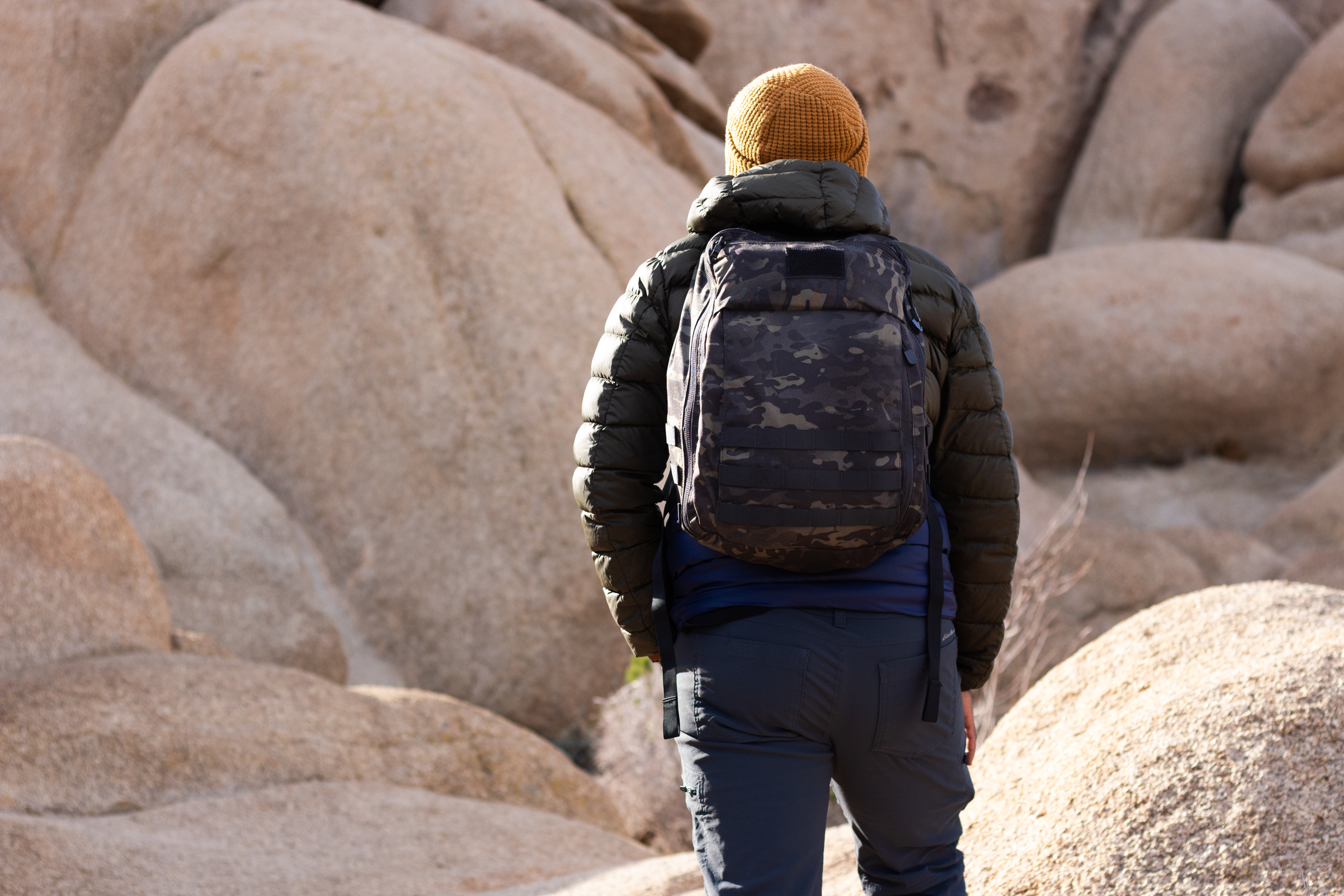 Image of a person at joshua tree wearing the prime pack in multicam black